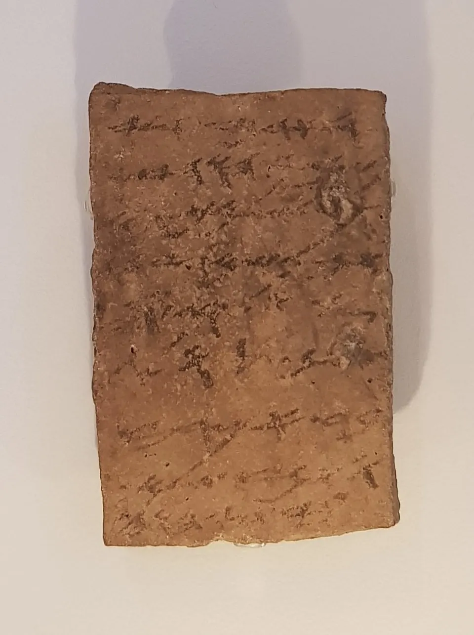 Potsherd inscribed in ink with cursive Hebrew letters