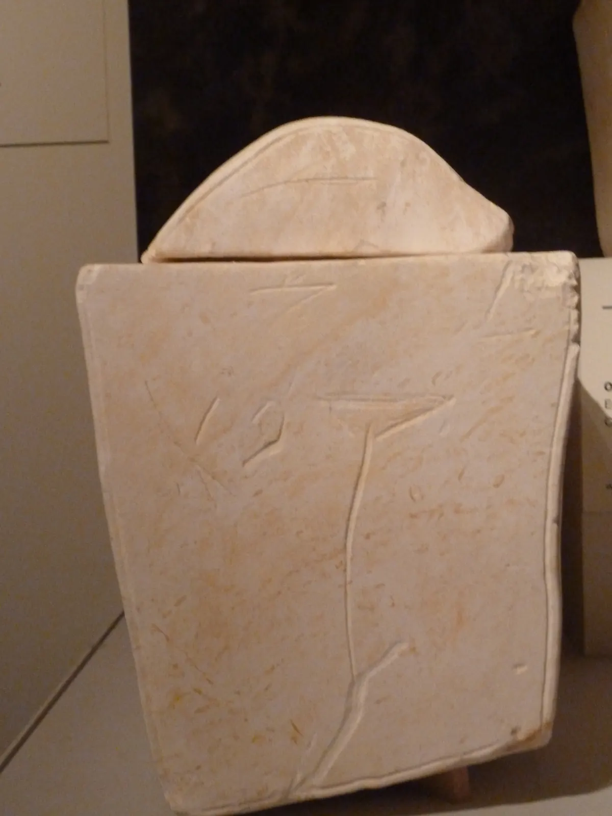 Carved limestone ossuary with two large rosettes