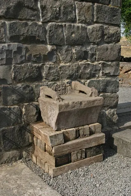 Carved black basalt armchair inside a ruined synagogue