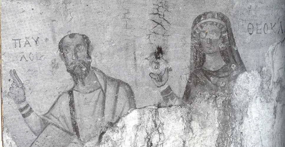 Faded wall painting of a bearded man holding a scroll beside a young woman at a window