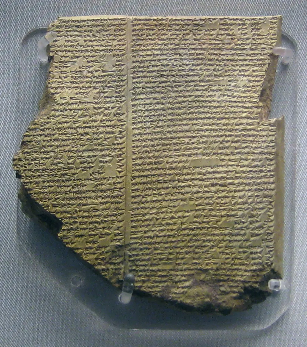 Broken clay tablet with dense cuneiform writing