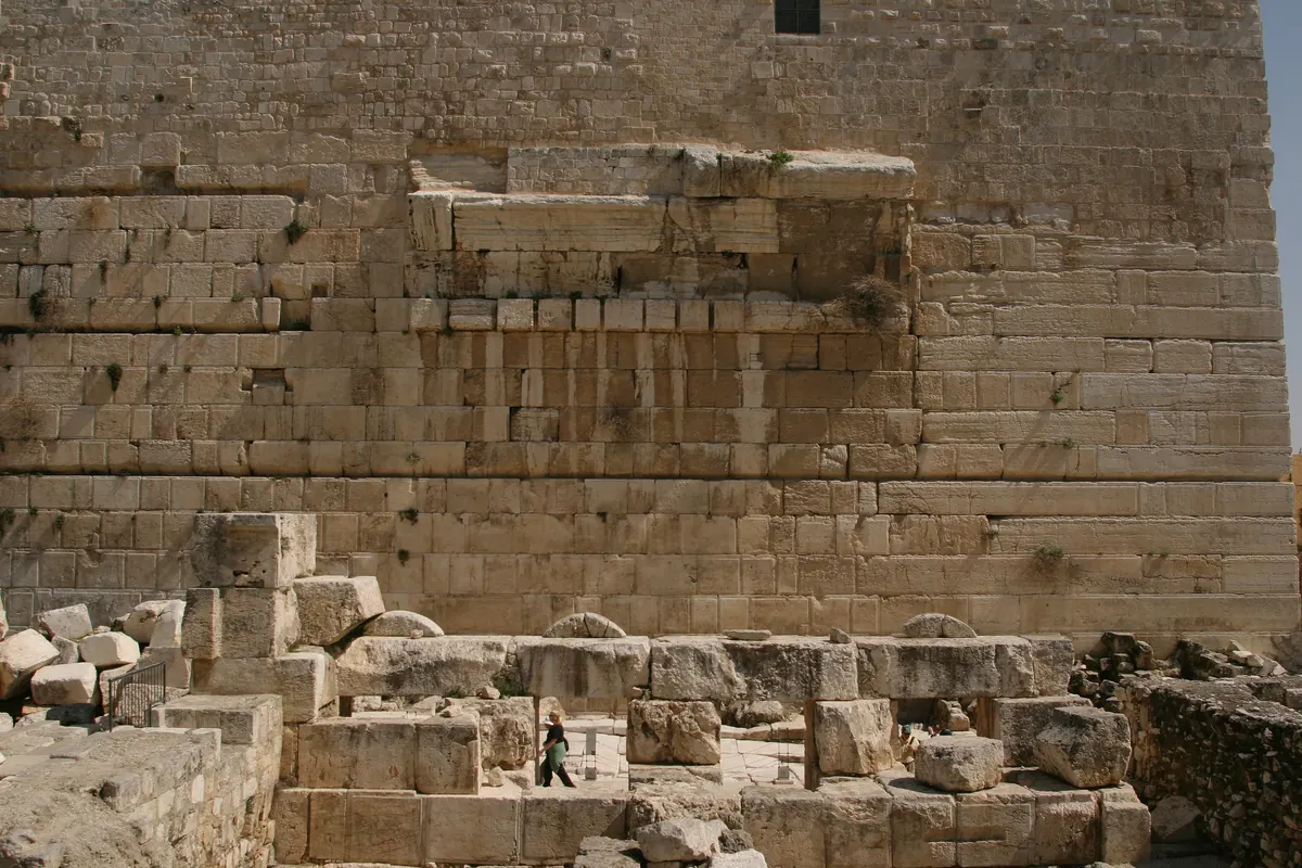 Pile of giant carved stones lying on an ancient paved street