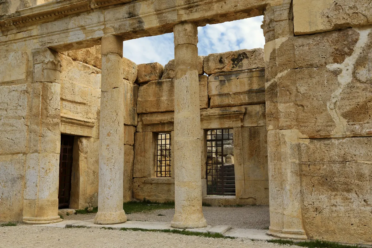 Large ancient stone building with carved animal reliefs