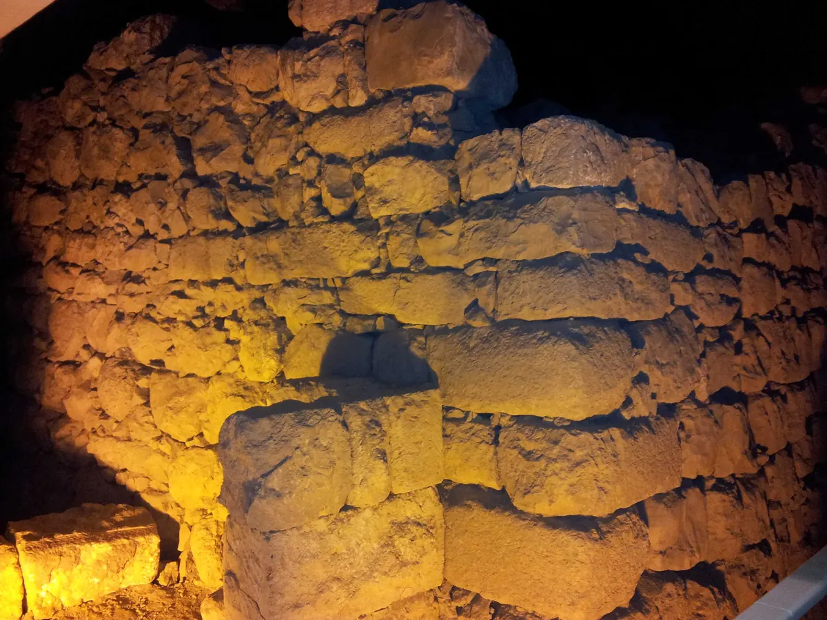 Massive Iron Age stone walls under a modern building