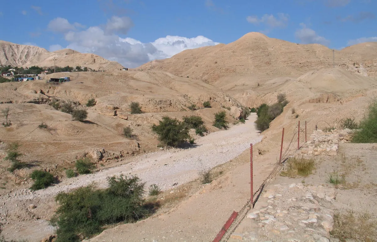 Ruined palace walls of diamond-pattern Roman concrete beside a dry riverbed