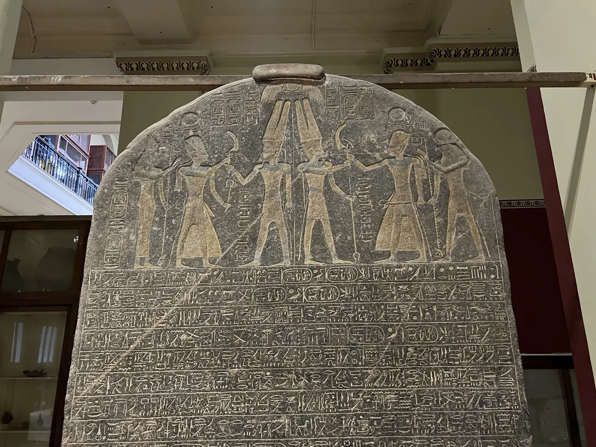 Tall black granite stele covered in hieroglyphs