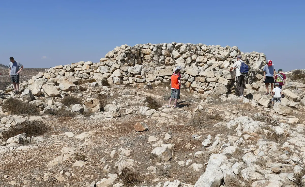 Rectangular fieldstone structure on a rocky hillside