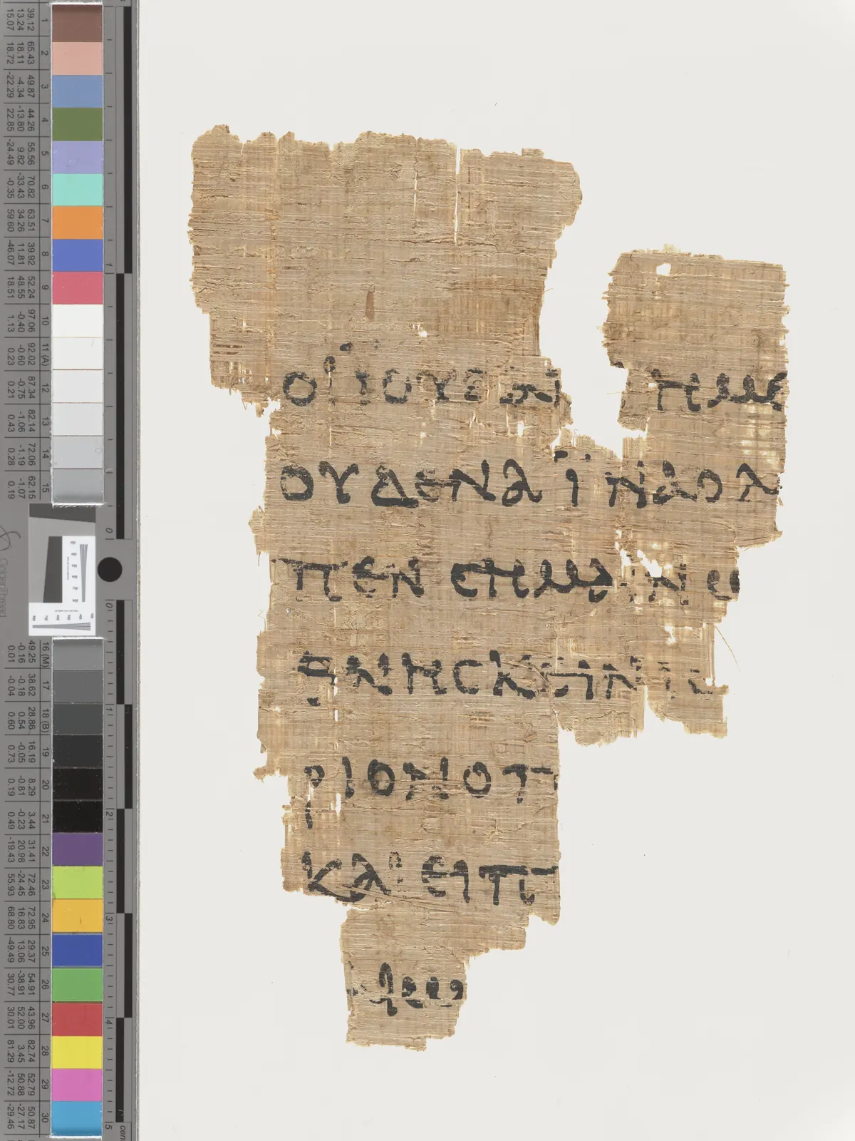 Small brown papyrus fragment with Greek letters