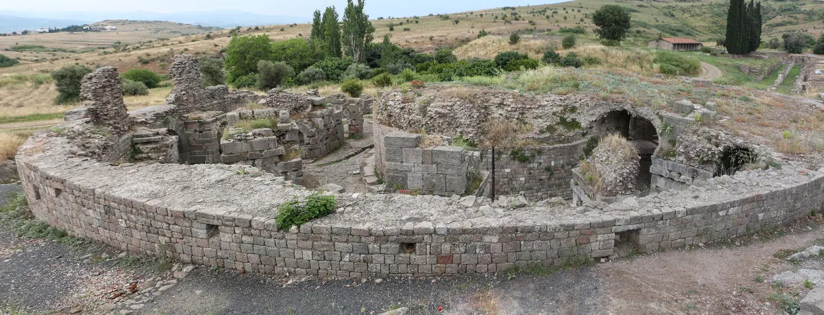 Ruined round brick building with arches in a Roman healing sanctuary