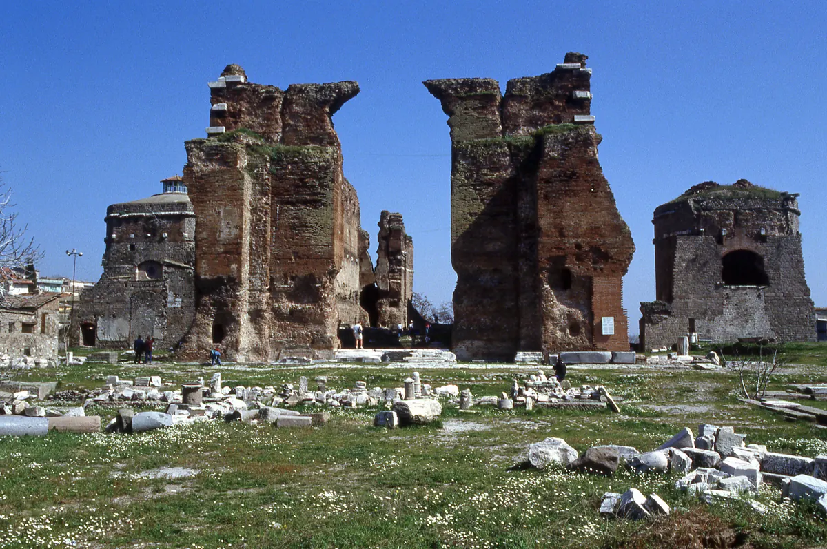 Massive red-brick Roman temple hall with a round tower