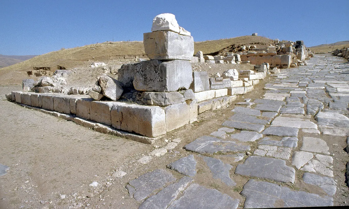 Semicircular rock-cut temple terrace with column fragments