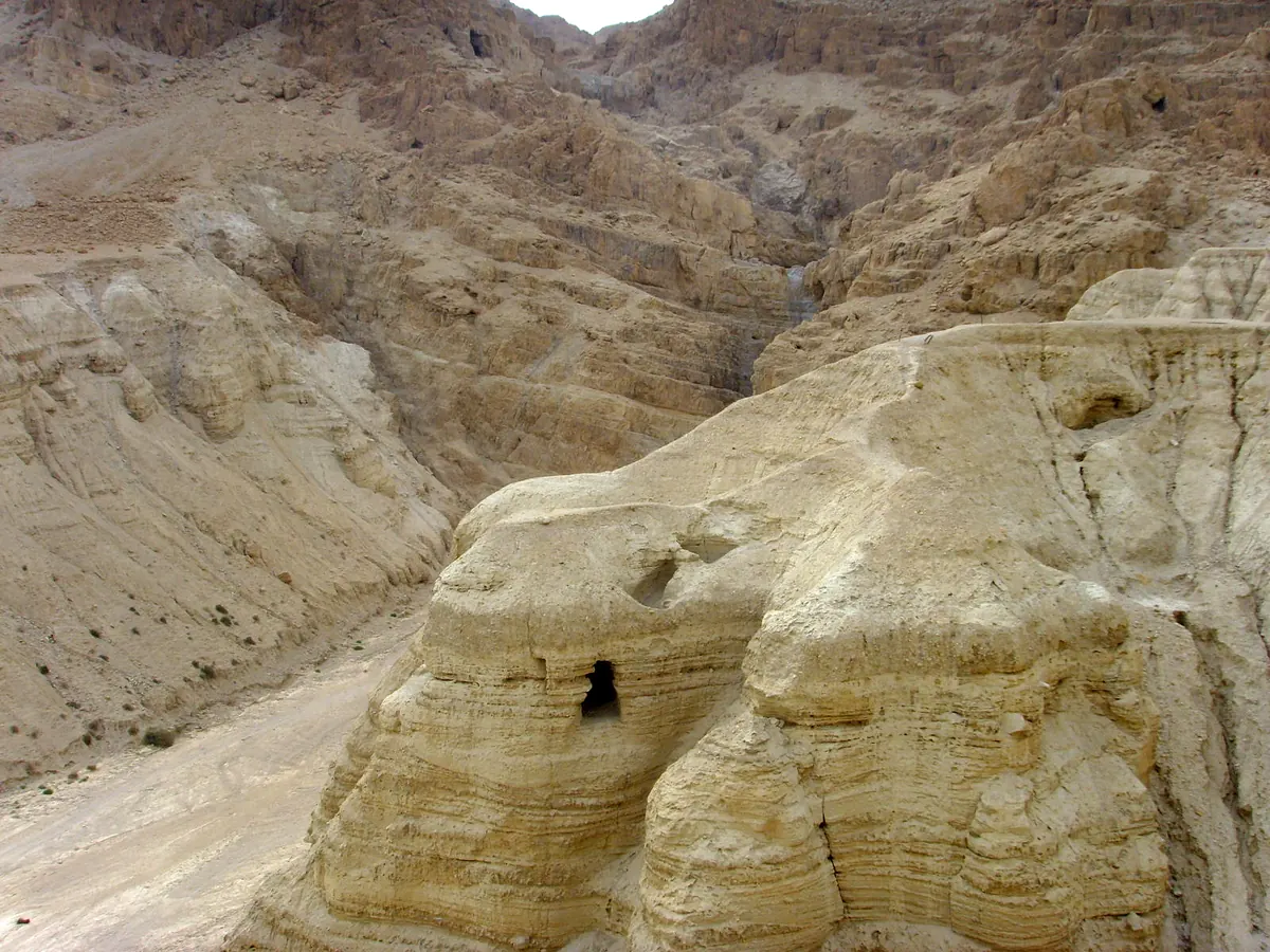 Low stone walls and cisterns of a desert ruin above a plain