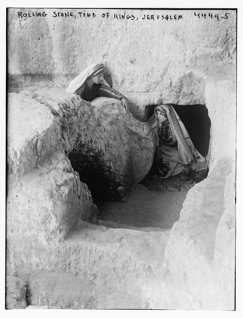 Large round stone disc standing in the groove beside a tomb doorway