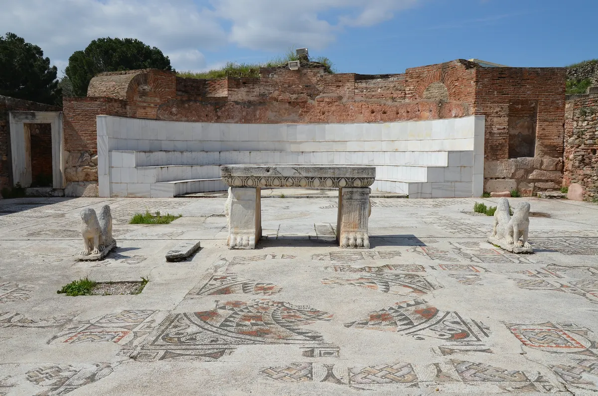 Long restored hall with mosaic floor and marble columns