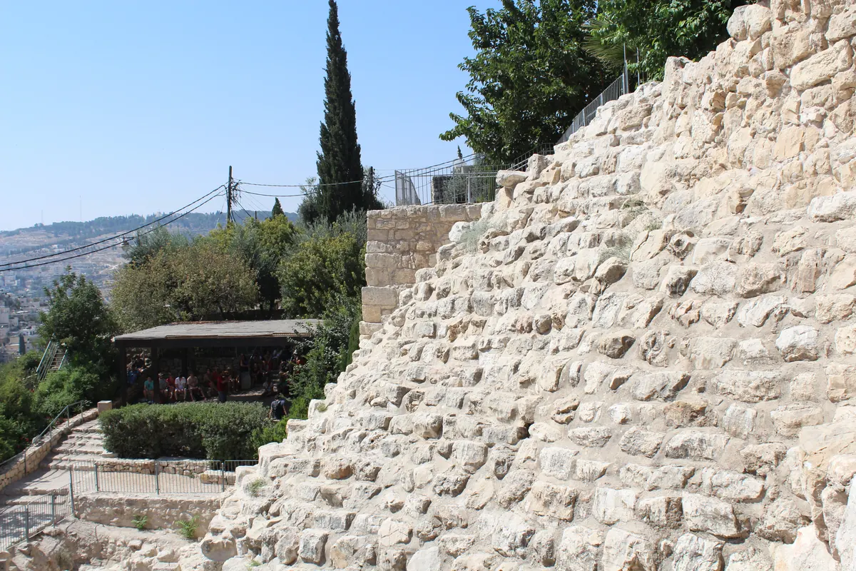 Tall stepped wall of fieldstones on a hillside