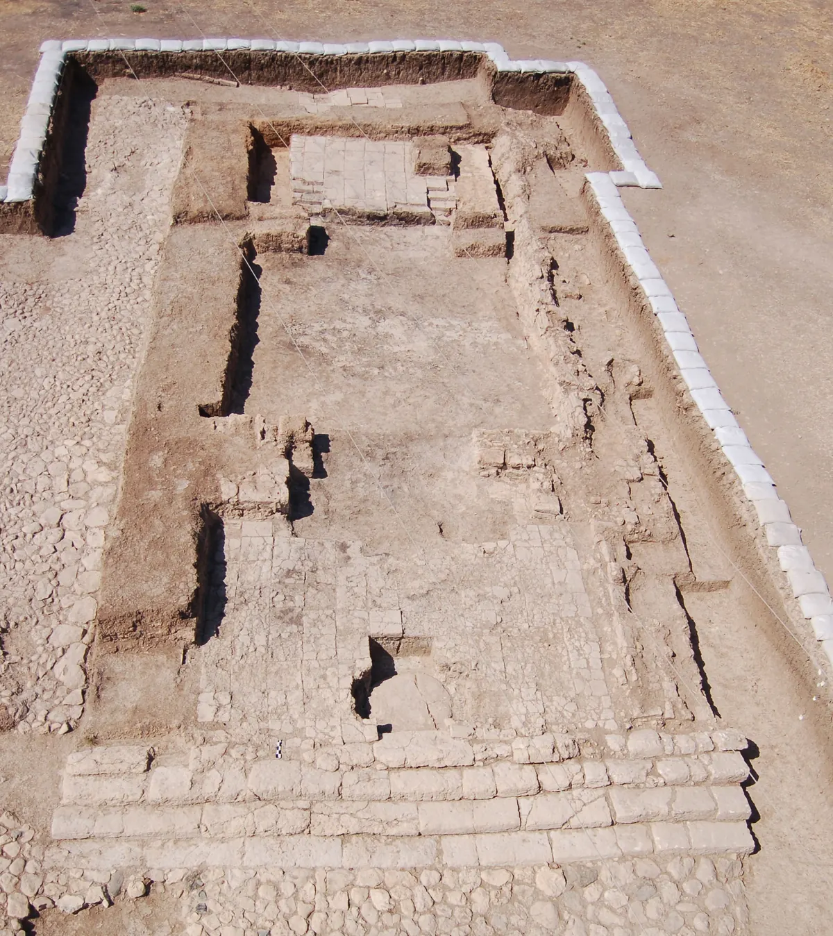 Excavated long-room temple foundations on a mound in Turkey