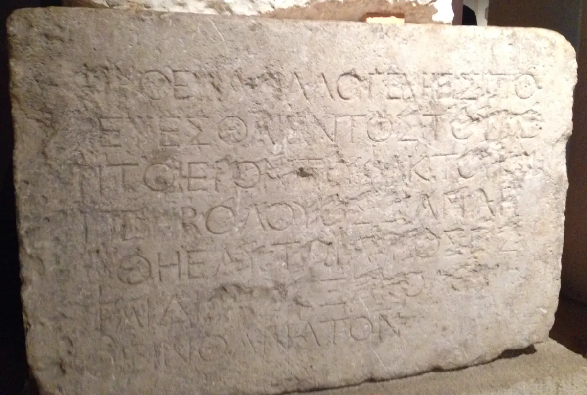 Rectangular stone slab with seven lines of Greek capitals