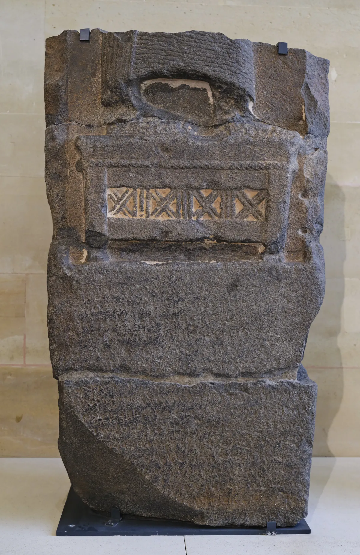 Broken basalt stele base with Aramaic inscription